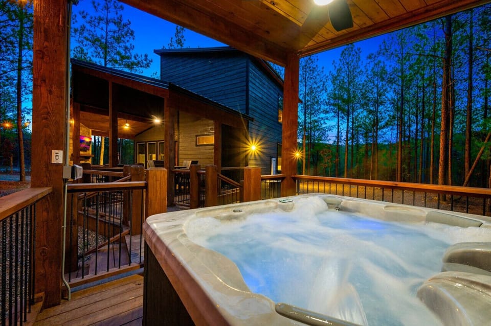 Soak away the day in the bubbling hot tub as the forest glows around you.