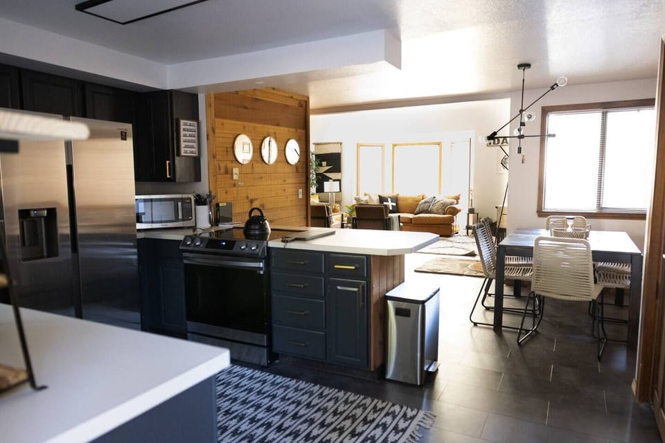 Prepare meals in a fully equipped kitchen featuring elegant gray accents and all the essentials for a comfortable stay