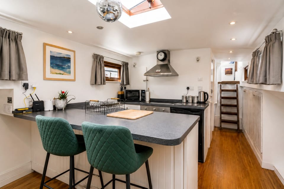 Galley and breakfast bar with stools, the spot for morning coffee aboard