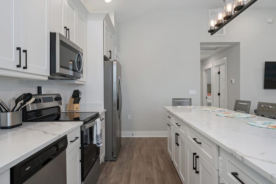 Modern kitchen with stainless steel appliances and ample storage.