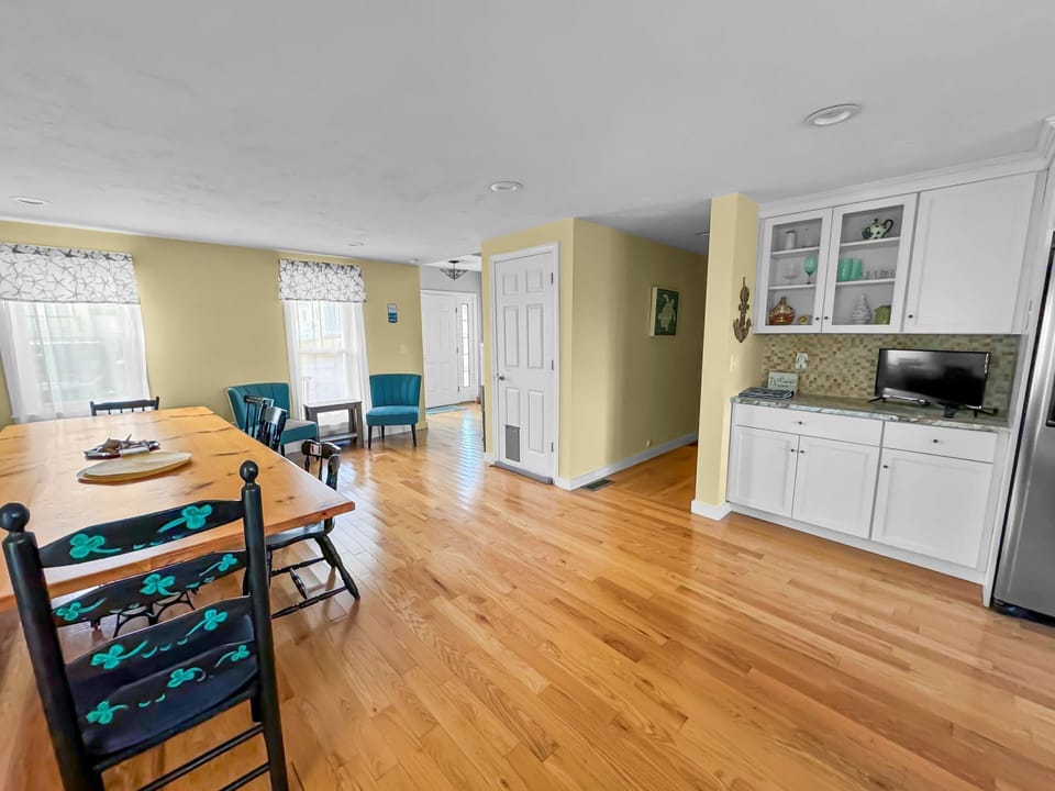Dining room looking toward entry way with Smart TV