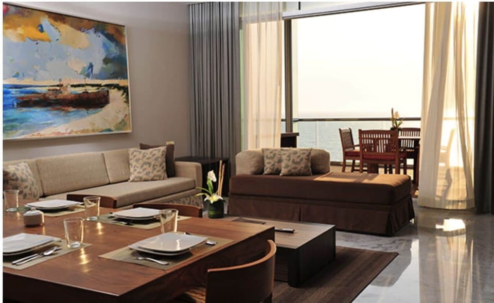 The living room and dining room with a sleeper sofa. 