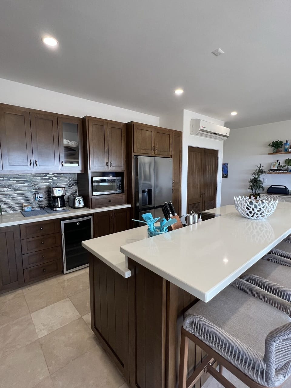 Fully stocked kitchen with stainless LG freezer/fridge, pantry and wine fridge.
