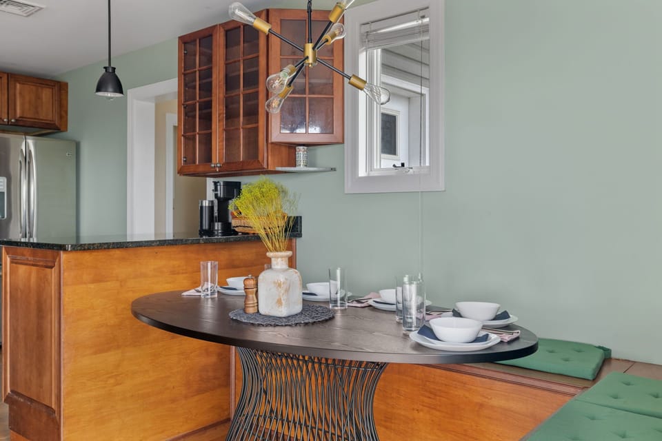 An inviting dining area with cozy banquet seating for five