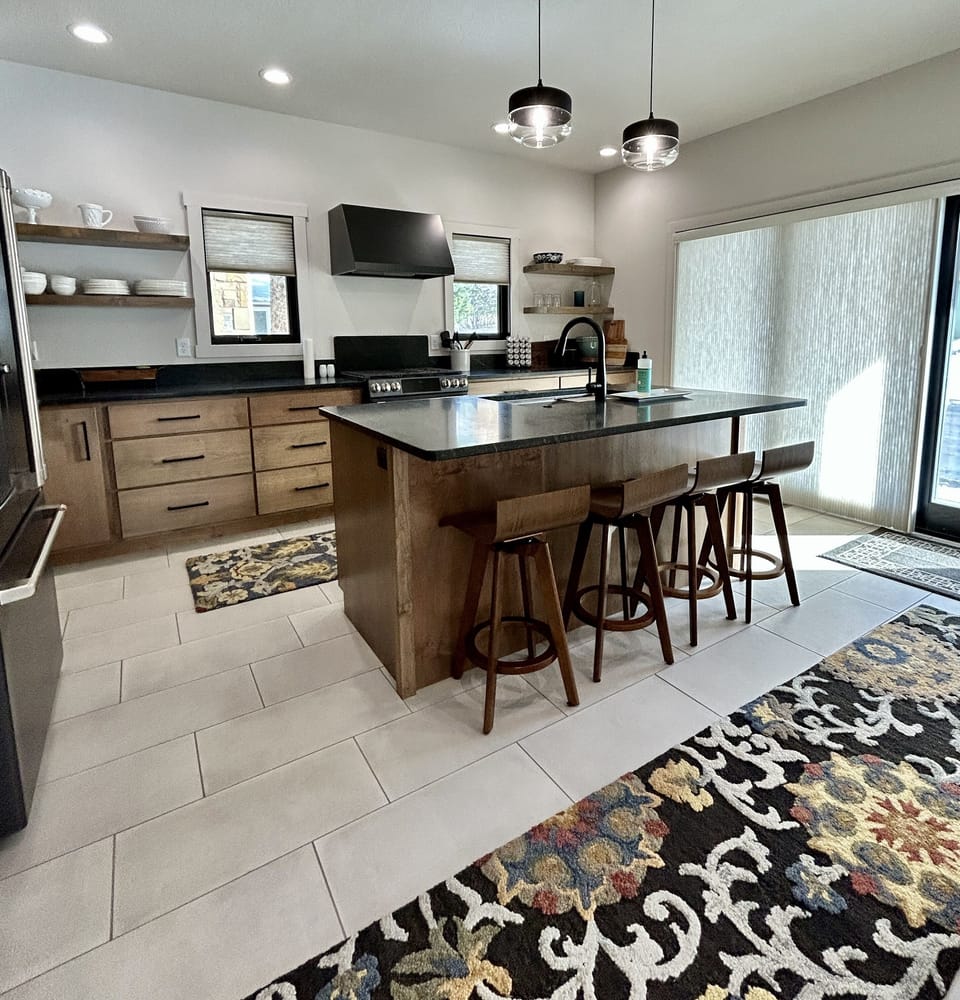 Large kitchen with glass wall --sliding door exits to wrap-around patio.