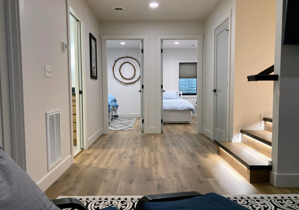 Downstairs view from TV room toward the 2 bedrooms and bathroom.