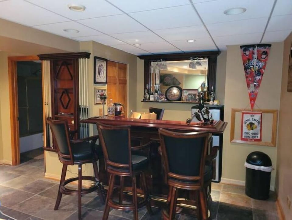 Bar with mini fridge & freezer. Full bathroom to left.