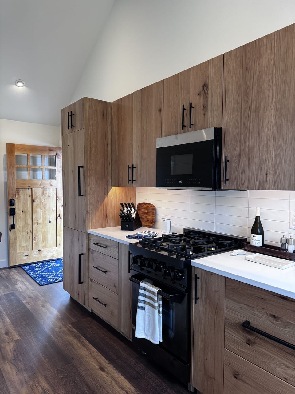View of entry to the kitchen with upscale sleek appliances and custom cabinetry