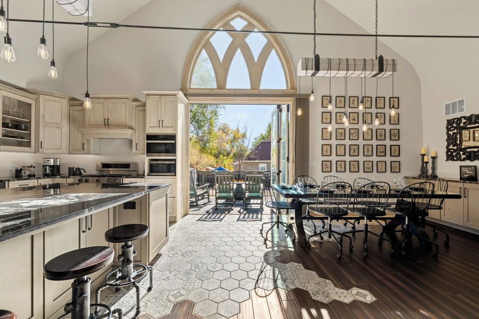 Dining Room, gothic window w/ custom door, gourmet island, and industrial table