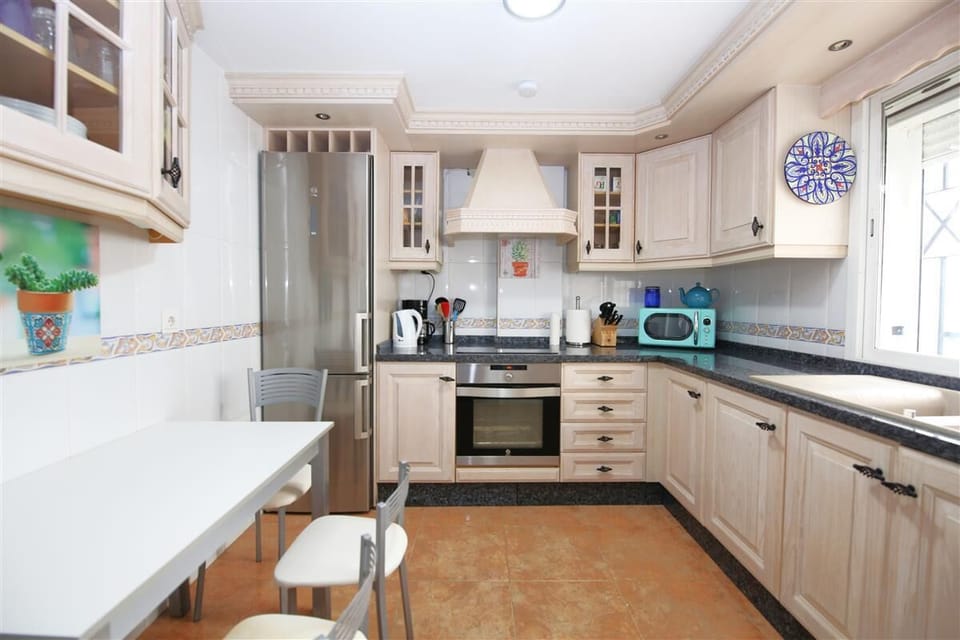 Kitchen in this apartment is fully equipped with all the appliances