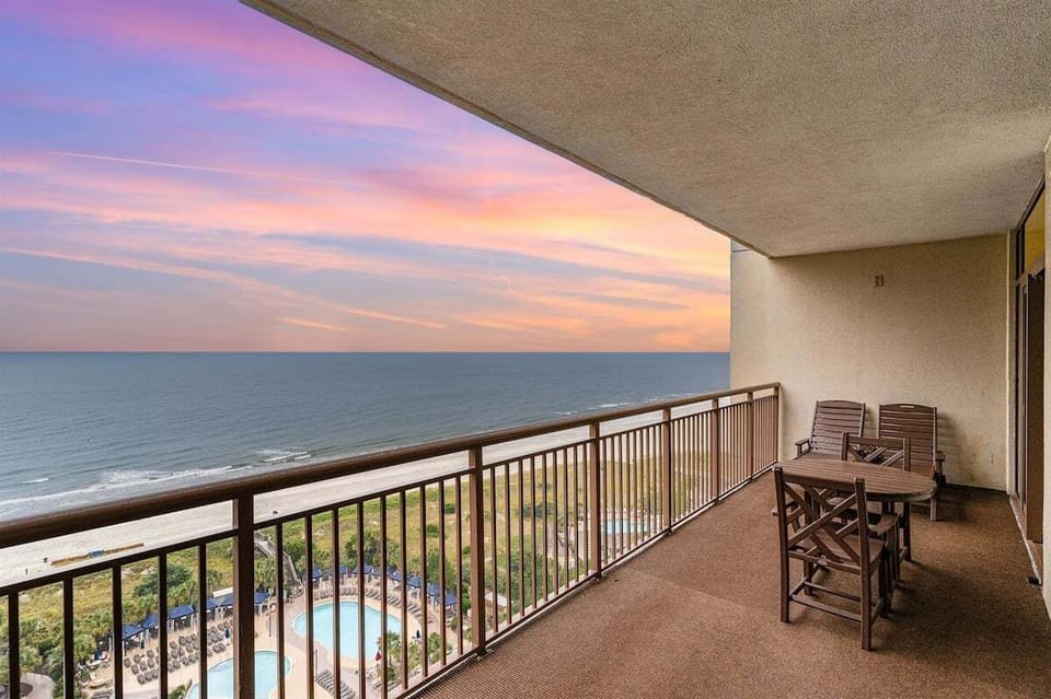 Enjoy stunning evening skies over the Atlantic from the spacious private balcony at Seacrest.