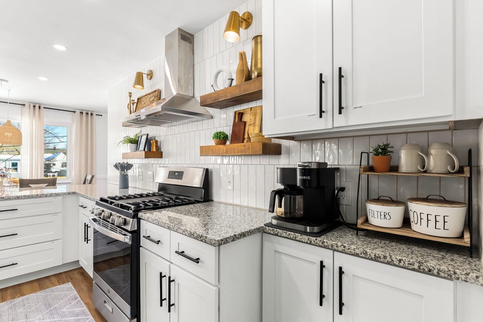 Transform your kitchen into a stylish haven with these white cabinets and a striking black stove. 🏡💫 Discover the joy of cooking in a space that reflects your impeccable taste!