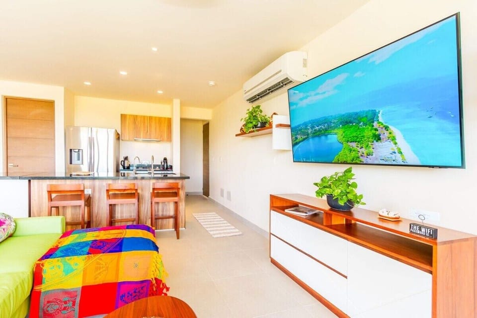 Wall-mounted Smart TV and a sofa for downtime at home