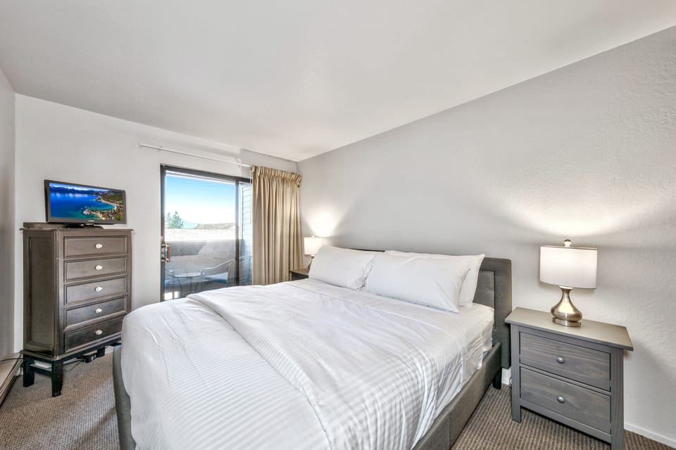 Sink into crisp linens and let the gentle lighting welcome you to your peaceful retreat with balcony views.