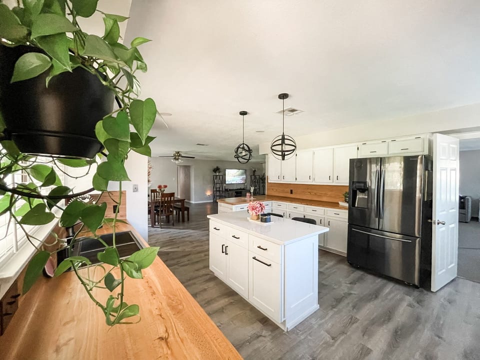 View from back door into open concept kitchen, dining, and family room