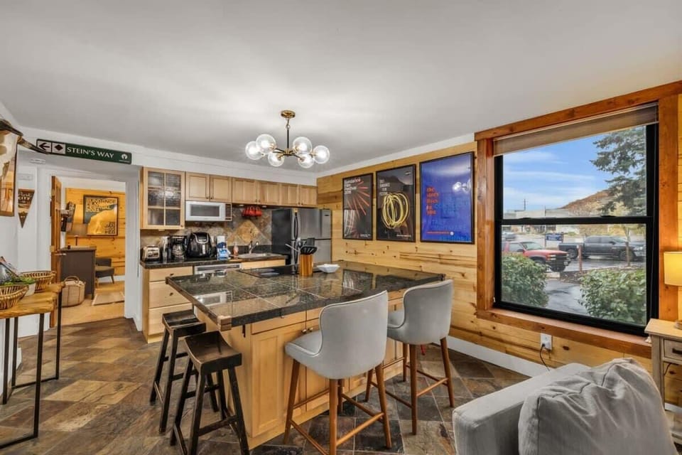 The fully-equipped kitchen has everything the chef in your group needs to prepare a delicious meal and includes a spacious kitchen bar that doubles as the dining table with seating for 4.