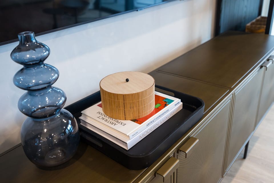 Cozy modern living room featuring a Smart TV, Patio access with city views and designer decor with plush furnishings.