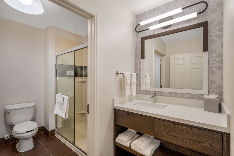 Refresh at the bright vanity with fresh towels ready.