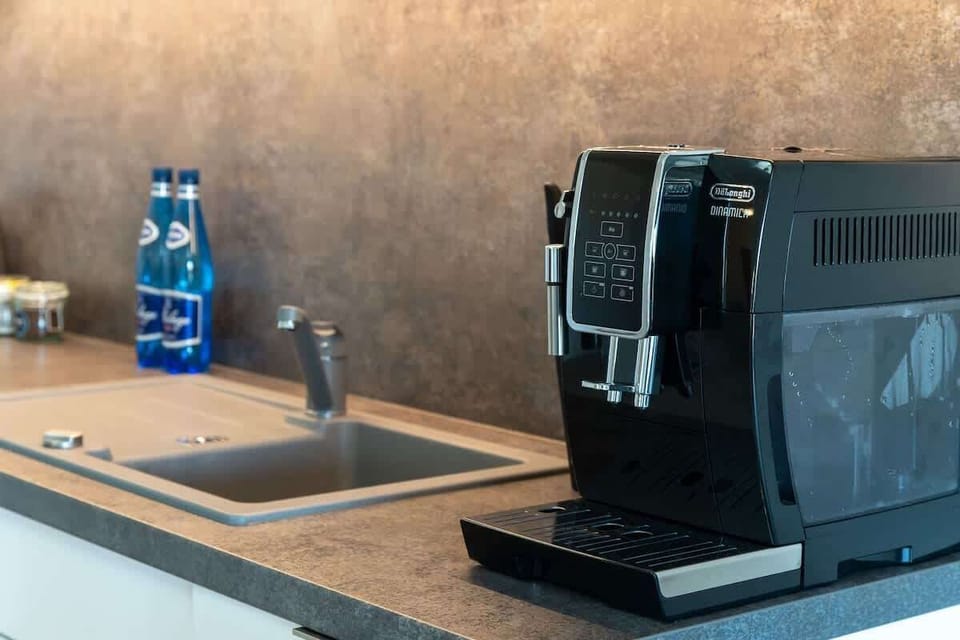 A close-up of a black coffee machine on a countertop, adding convenience and style to the kitchen setup.

