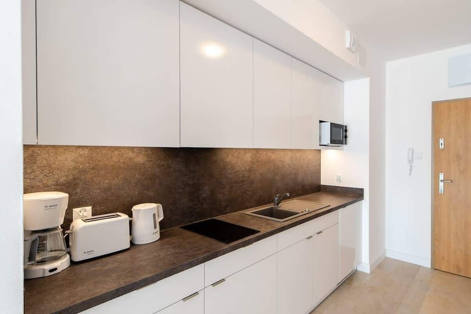 Another perspective of the kitchen, showcasing its clean lines, modern appliances, and a functional design.
