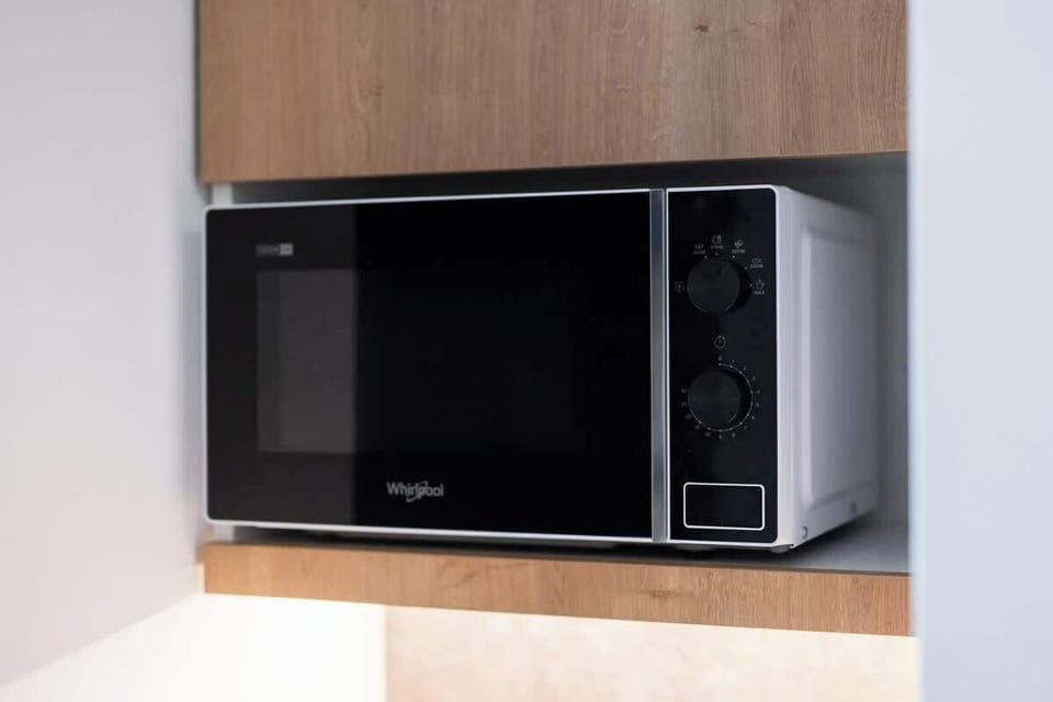 A modern microwave integrated into the kitchen design, providing a functional yet stylish appliance.
