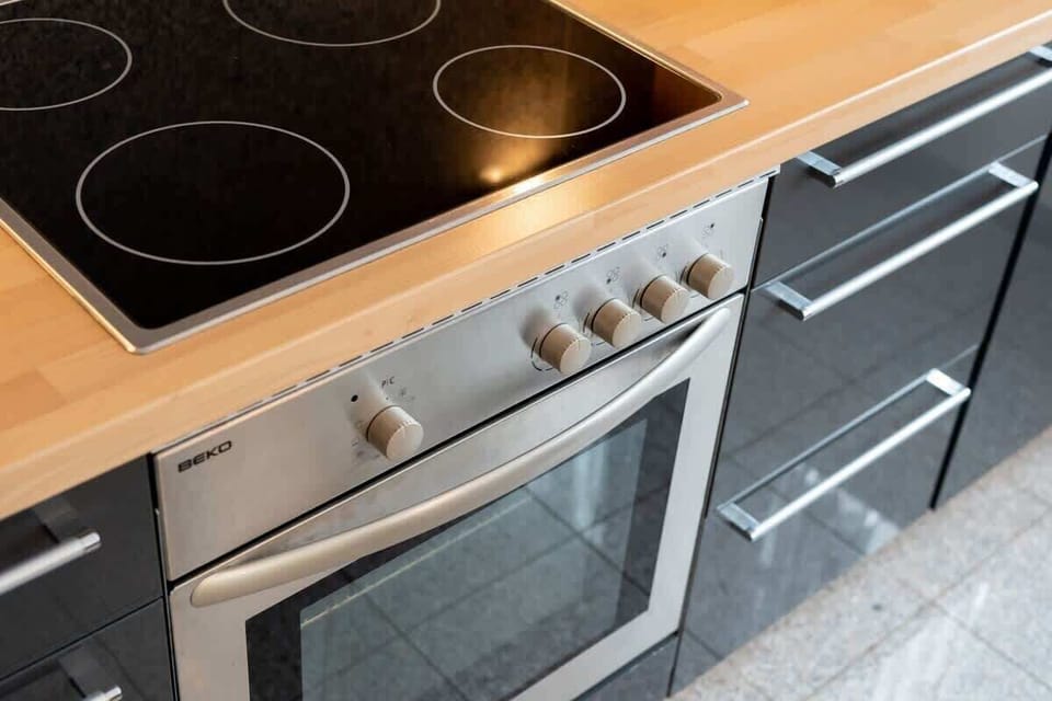 A close-up of a modern stovetop and oven, highlighting the kitchen’s practicality.
