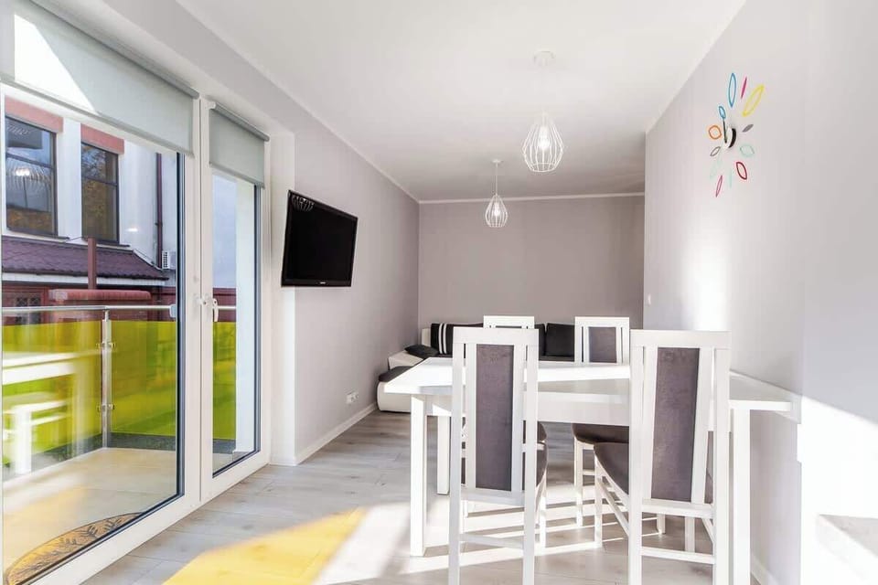 A spacious dining area with large windows, allowing natural light to fill the room.
