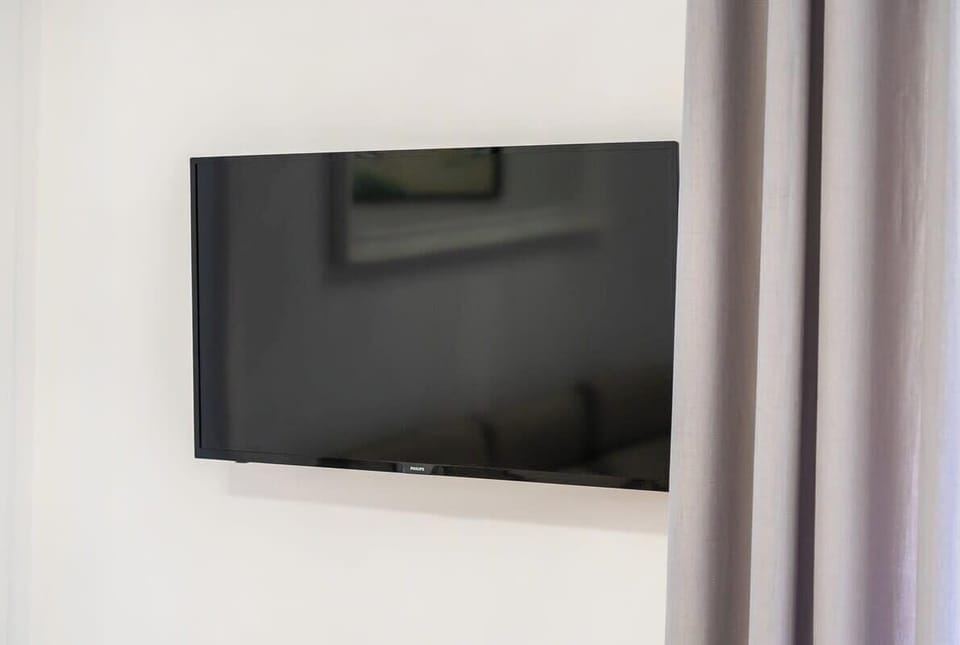 A wall-mounted TV in the bedroom, blending modern entertainment with a minimalist design.
