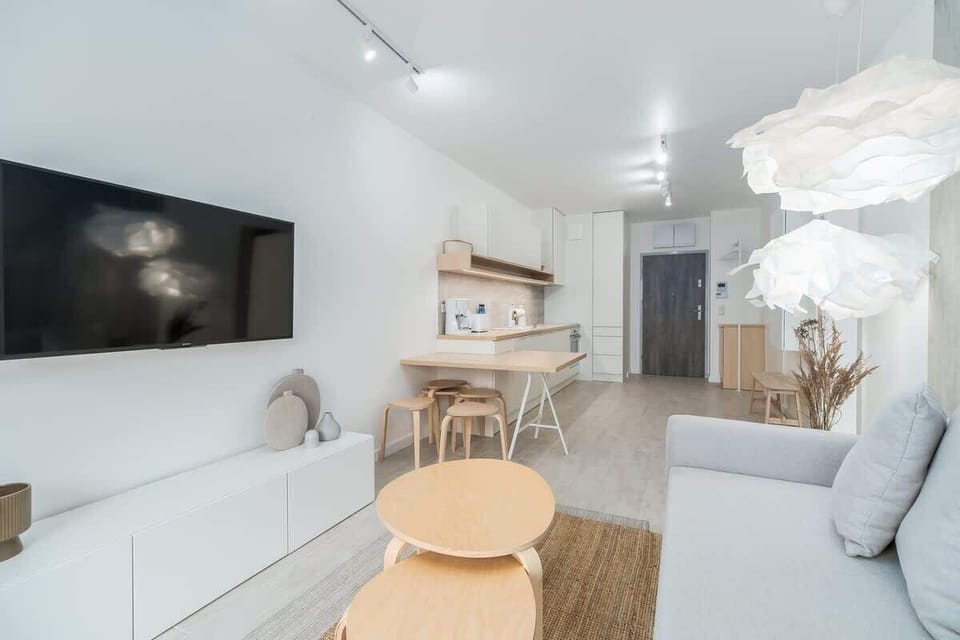 A dining area adjacent to the kitchen, featuring a light wooden table and matching chairs.
