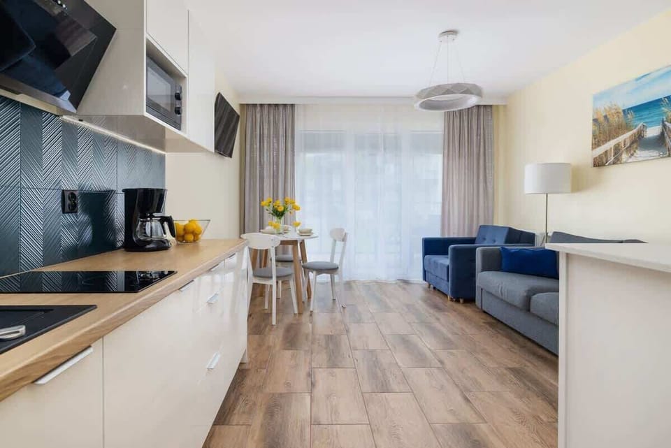 Another angle of the kitchen and dining area, showing the spacious layout and bright interiors.
