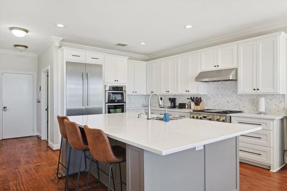 Featuring quartz countertops, stainless steel appliances, and a beautiful center kitchen island with seating, this kitchen is as polished as they come!