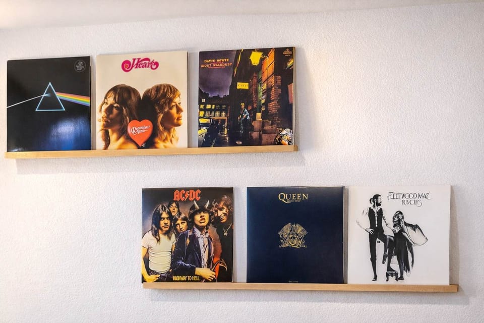 A fun retro corner with vinyl records and a neon sign that sets the vibe.