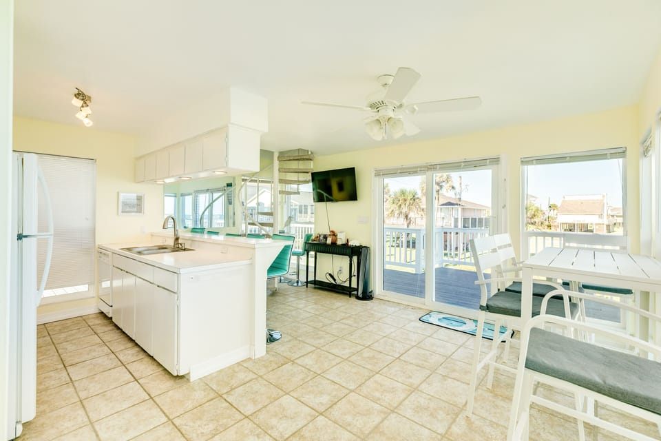 Main level dining and kitchen area with easy deck access, or head up the spiral staircase to the living area