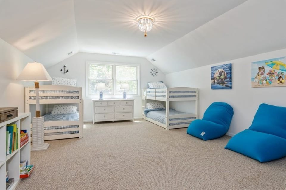 Bunk bedroom with large play space. Has a 65 inch Smart TV and Nintendo Switch