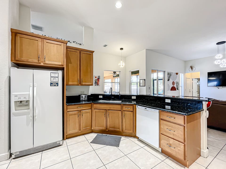 Sleek black granite countertops, comfy stool seating, and plenty of storage in the roomy cabinets