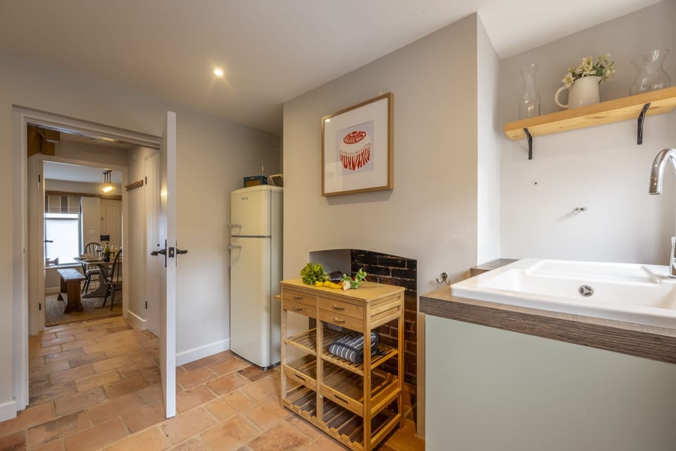 Ground floor: Kitchen with ornamental fireplace looking to dining room