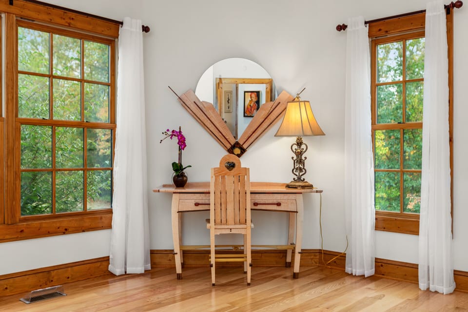 The main floor king bedroom suite has a custom-made exotic wood desk & chair. 