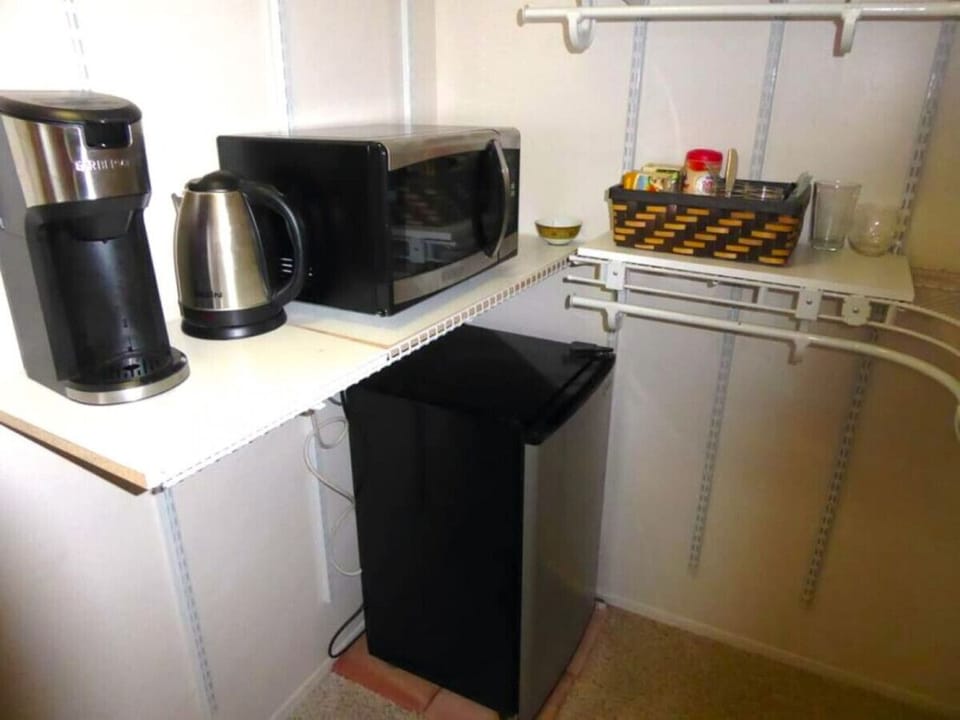 Mini-fridge, coffee maker (replaced with a new one), electric kettle, and microwave in walk-in closet.