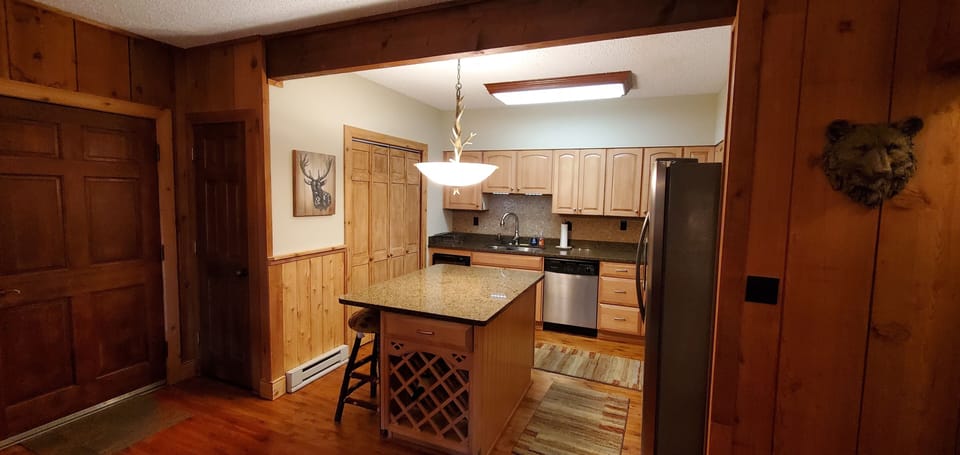 Showing the kitchen and laundry area (foldable doors on left)