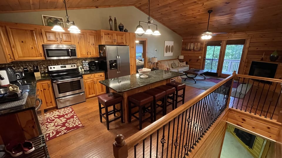 Warm wood interior featuring full kitchen, dining island, and open living space.