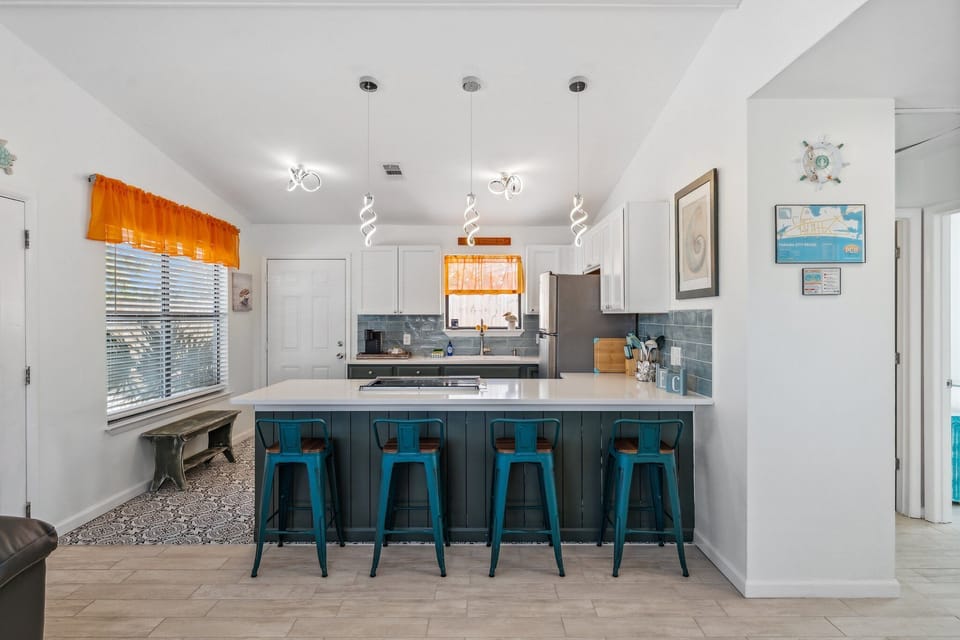 Fully Stocked Kitchen with Stainless Steel Appliances and Bar Seating