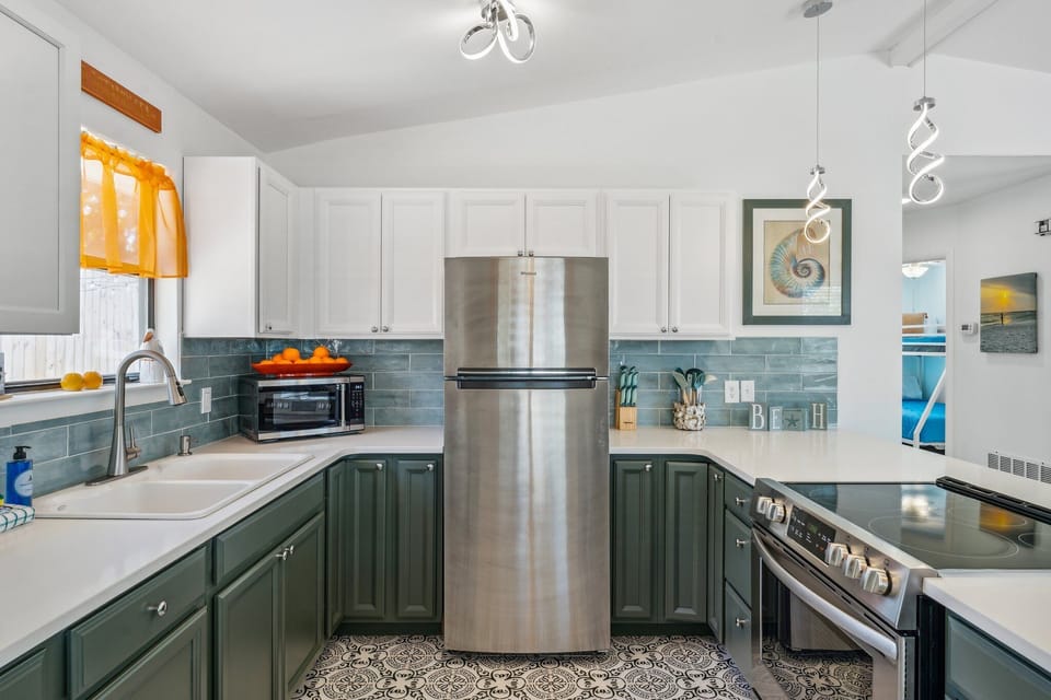 Fully Stocked Kitchen with Stainless Steel Appliances and Bar Seating