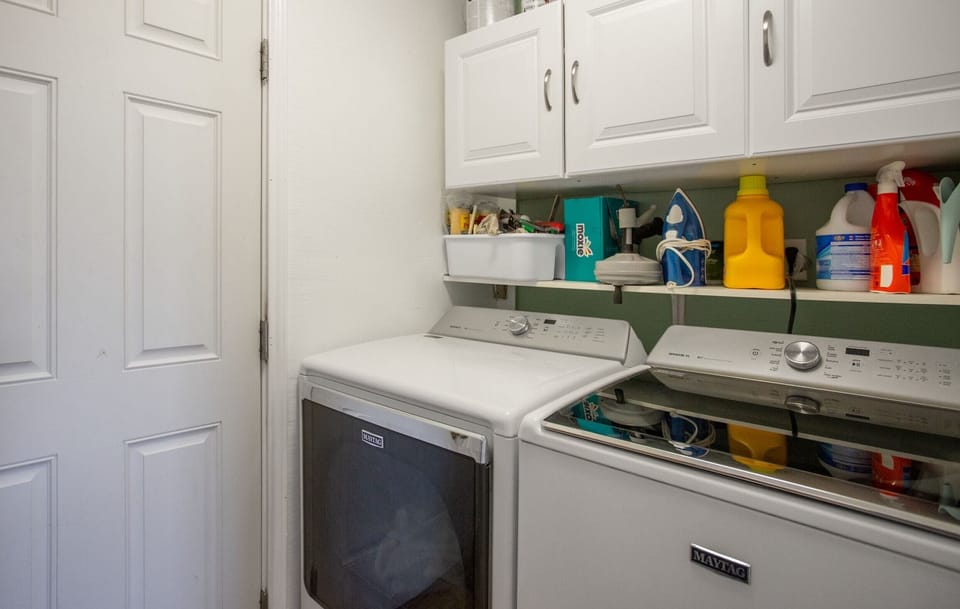 Washer and dryer w Laundry Soap and dryer sheets, Iron and small Ironing Board.