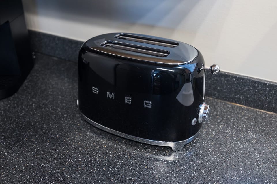 Start your day off right with this modern black toaster in your kitchen setup