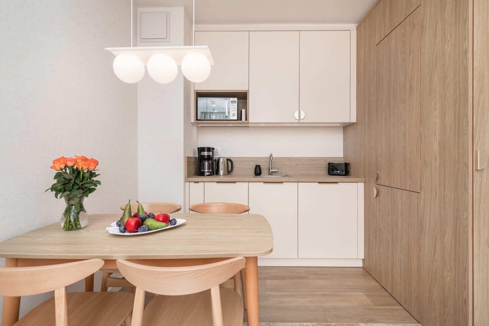 Kitchenette with a microwave and practical cabinets.