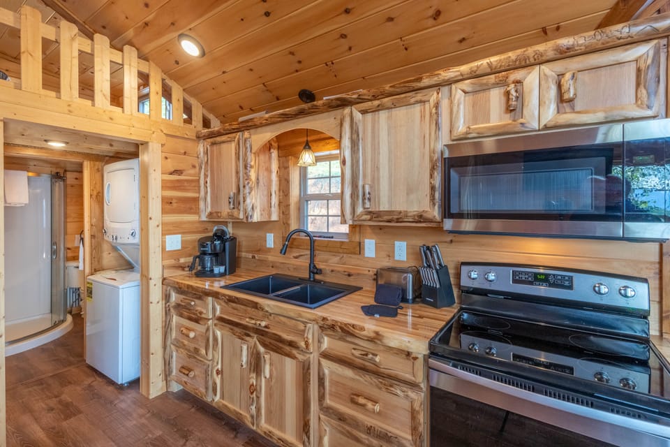 Kitchen - Kitchen with regular coffee pot, stove, and microwave