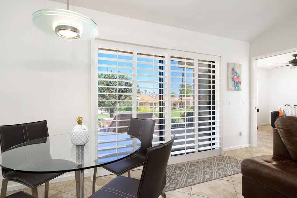 Custom plantation shutters and designer shades throughout 