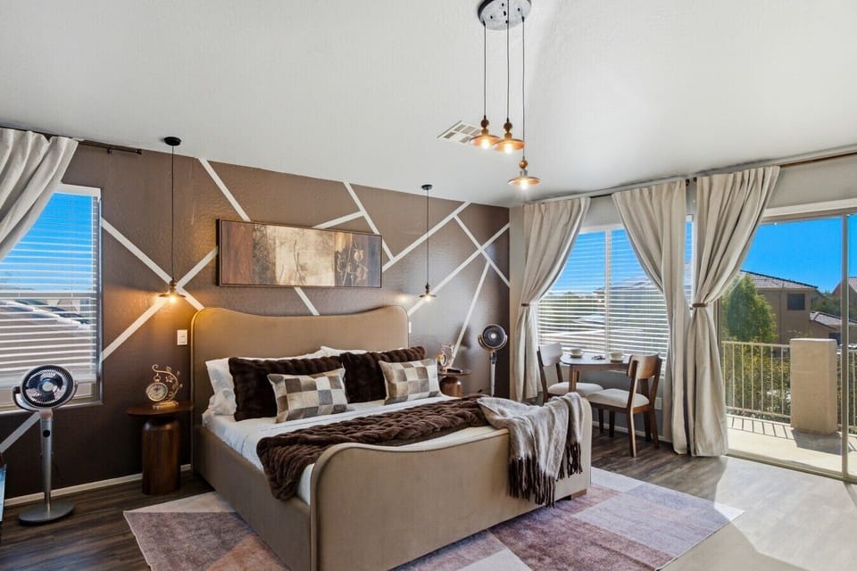 👑 Luxury Primary Bedroom Retreat — Relax in the elegant king suite featuring stylish décor, natural light, Smart TV, comfortable furnishings, and a peaceful Arizona getaway atmosphere.
