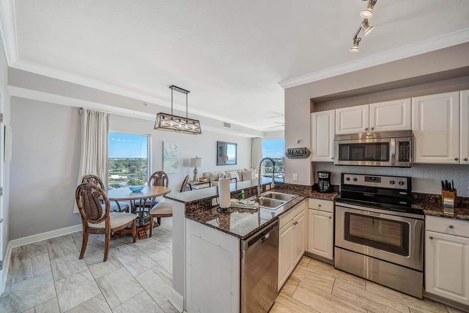 The fully equipped kitchen features granite countertops and stainless-steel appliances.