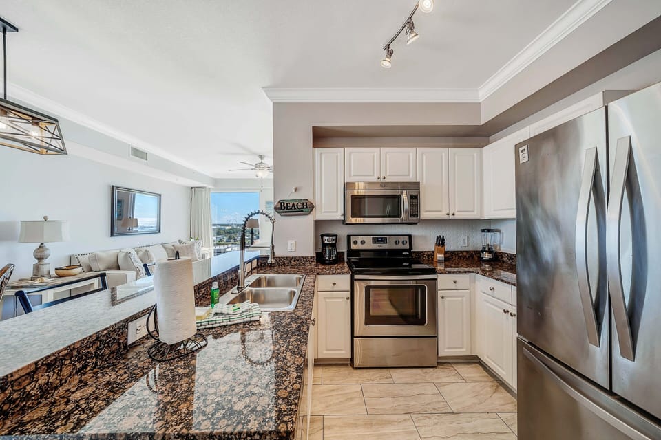 The fully equipped kitchen features granite countertops and stainless-steel appliances.